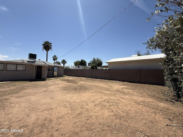 view of yard featuring cooling unit and fence
