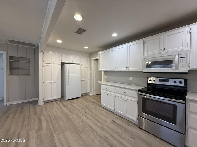 kitchen featuring visible vents, white cabinets, light countertops, light wood-type flooring, and white appliances