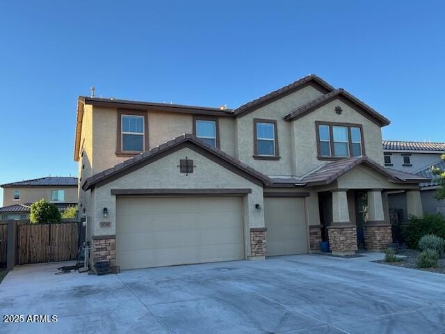 18740 W San Juan Ave, Litchfield Park, AZ 85340 - view of front of property featuring stone siding, an attached garage, stucco siding, and concrete driveway