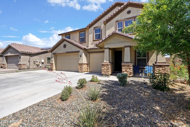 18740 W San Juan Ave, Litchfield Park, AZ 85340 - view of front of house with stucco siding, stone siding, driveway, covered porch, and a tiled roof