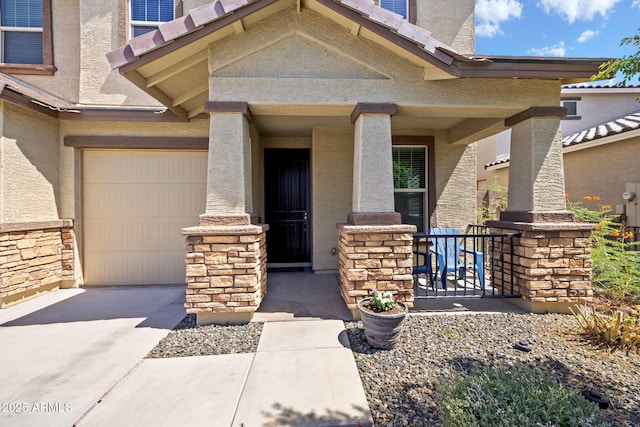 18740 W San Juan Ave, Litchfield Park, AZ 85340 - property entrance with concrete driveway, stucco siding, a porch, and stone siding