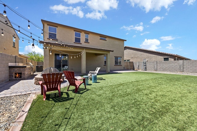 18740 W San Juan Ave, Litchfield Park, AZ 85340 - back of property featuring a patio, stucco siding, and an outdoor stone fireplace