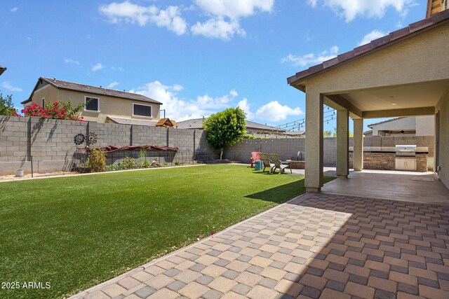 18740 W San Juan Ave, Litchfield Park, AZ 85340 - view of yard featuring a patio area and exterior kitchen