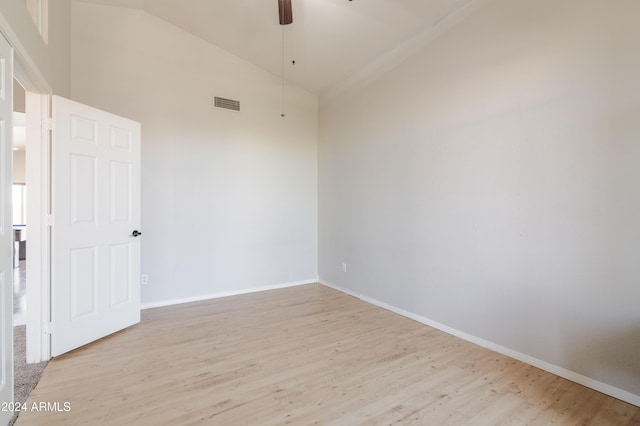 empty room with light wood finished floors, baseboards, visible vents, and a ceiling fan