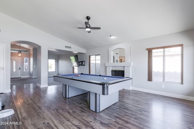 game room with visible vents, arched walkways, dark wood-type flooring, vaulted ceiling, and a fireplace