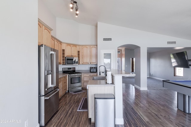 kitchen with an island with sink, light brown cabinets, visible vents, and stainless steel appliances