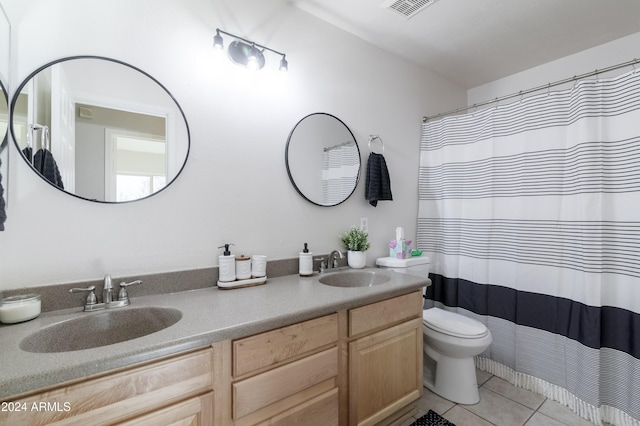 bathroom featuring double vanity, tile patterned flooring, visible vents, and a sink