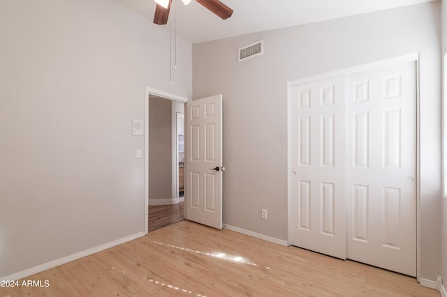 unfurnished bedroom with light wood-type flooring, baseboards, visible vents, and a closet