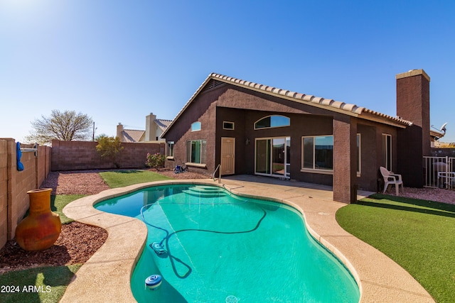 view of swimming pool featuring a patio, a lawn, a fenced backyard, and a fenced in pool