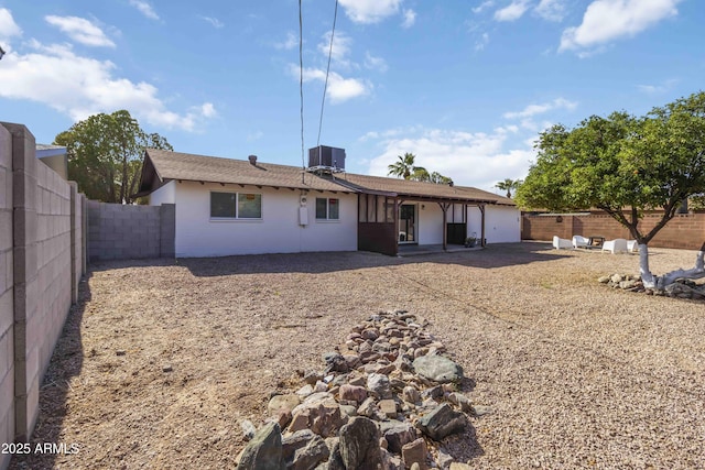 224 N 58th St, Mesa, AZ 85205 - back of property featuring a garage, central AC unit, a patio area, a fenced backyard, and stucco siding