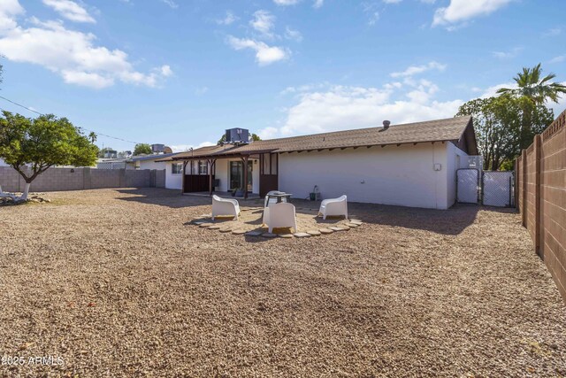 224 N 58th St, Mesa, AZ 85205 - back of house with a fenced backyard, a gate, and stucco siding