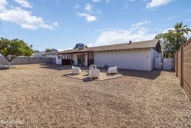 224 N 58th St, Mesa, AZ 85205 - back of house with a fenced backyard, a gate, and stucco siding