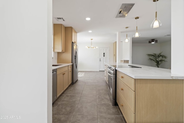 224 N 58th St, Mesa, AZ 85205 - kitchen with stainless steel appliances, light brown cabinets, a chandelier, decorative light fixtures, and recessed lighting