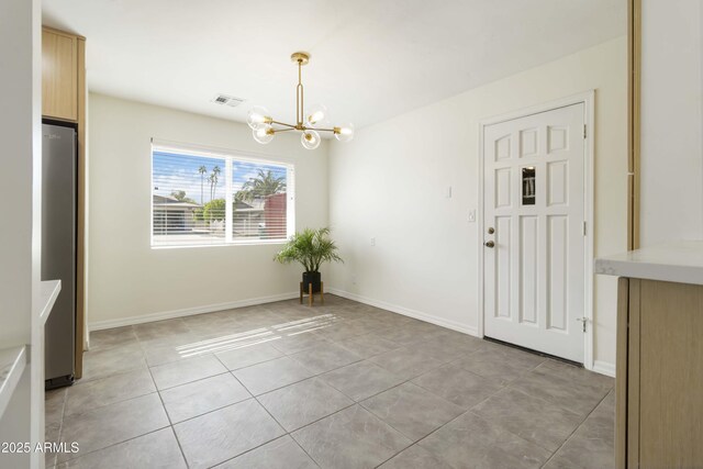 224 N 58th St, Mesa, AZ 85205 - unfurnished dining area with a chandelier, light tile patterned floors, and baseboards