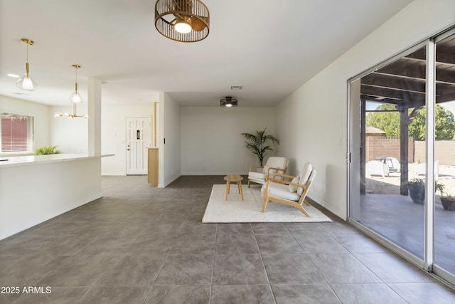 224 N 58th St, Mesa, AZ 85205 - dining area with tile patterned floors, baseboards, and a chandelier