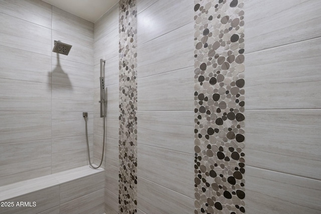 full bath with tiled shower