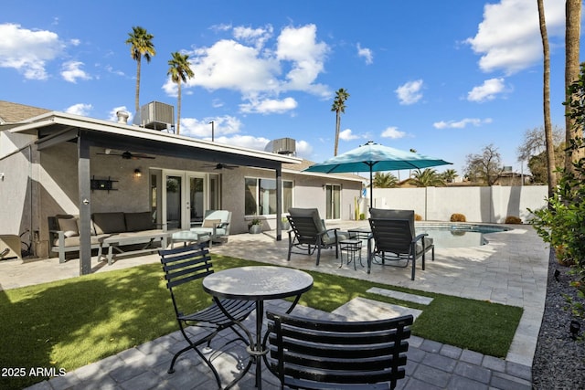 exterior space featuring a fenced in pool, french doors, outdoor lounge area, fence, and ceiling fan