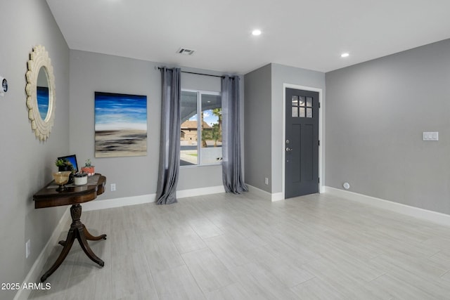 foyer featuring baseboards, visible vents, and recessed lighting