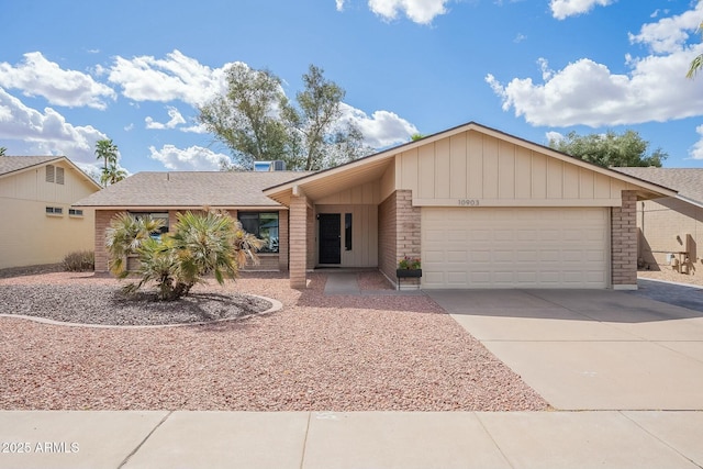 view of front of house with concrete driveway, a shingled roof, and an attached garage