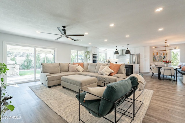 living room featuring light wood-type flooring, a wealth of natural light, and recessed lighting