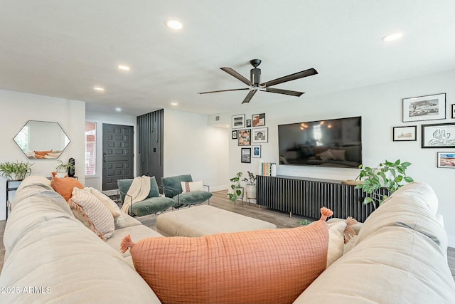 living area featuring ceiling fan, baseboards, wood finished floors, and recessed lighting