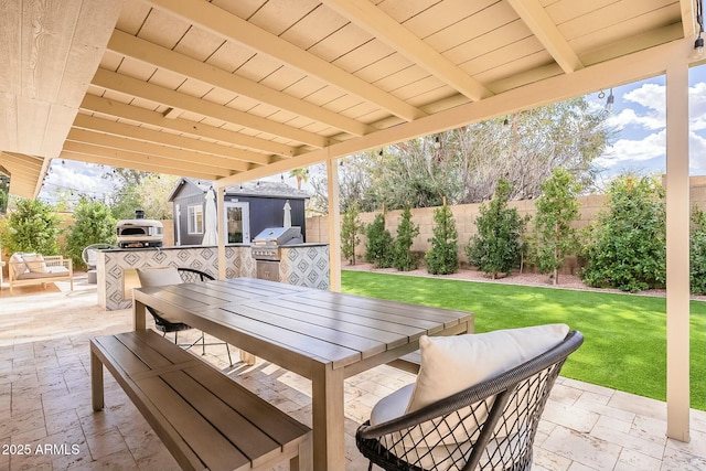 view of patio / terrace with outdoor dining space, a fenced backyard, an outbuilding, and area for grilling