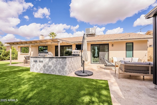 rear view of house featuring central air condition unit, an outdoor hangout area, exterior kitchen, a lawn, and a patio area