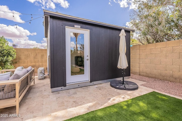 view of outdoor structure with an outbuilding and a fenced backyard