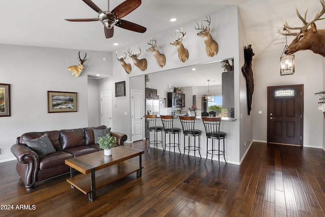 living room with ceiling fan, high vaulted ceiling, and hardwood / wood-style flooring