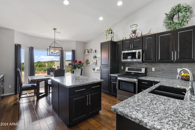 kitchen featuring dark wood-type flooring, backsplash, stainless steel appliances, and sink