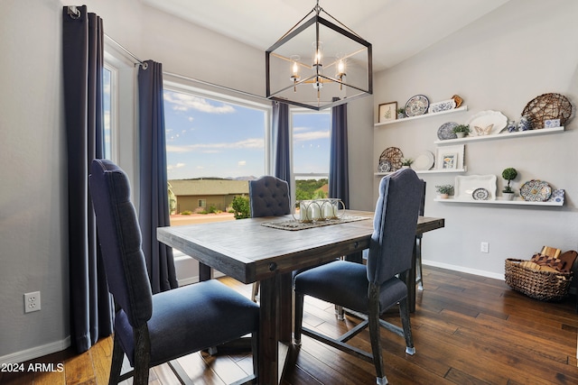 dining area with wood-type flooring and a chandelier