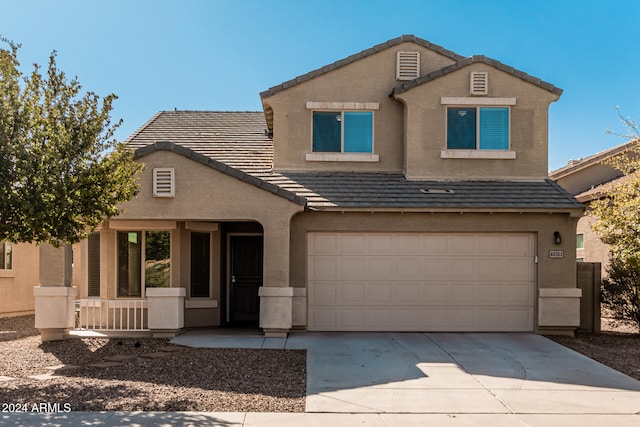 view of front property with a garage and a porch