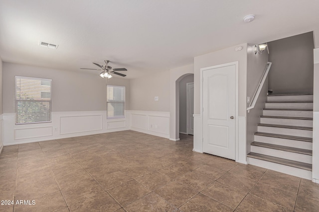 unfurnished living room with ceiling fan and tile patterned flooring