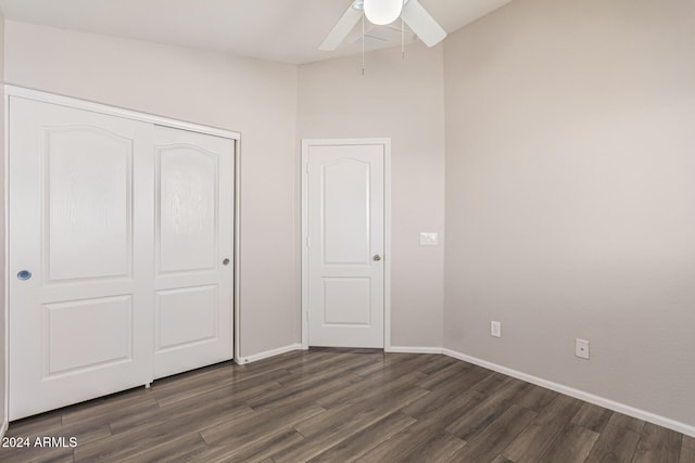 unfurnished bedroom with dark hardwood / wood-style floors, a closet, and ceiling fan