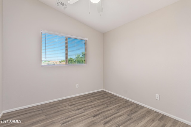 unfurnished room featuring ceiling fan, vaulted ceiling, and hardwood / wood-style floors