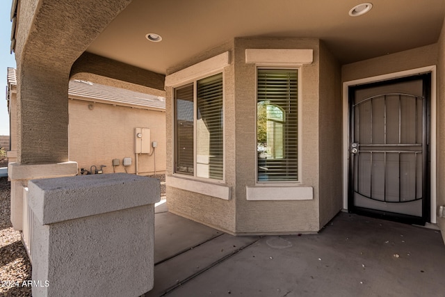 doorway to property with a patio area