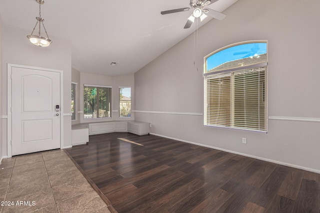 foyer featuring a healthy amount of sunlight, high vaulted ceiling, and dark hardwood / wood-style flooring