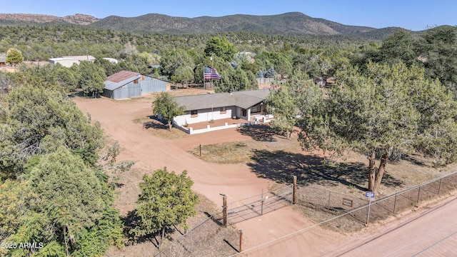 birds eye view of property with a wooded view and a mountain view