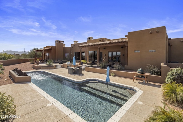 view of swimming pool with a fenced in pool and a patio area