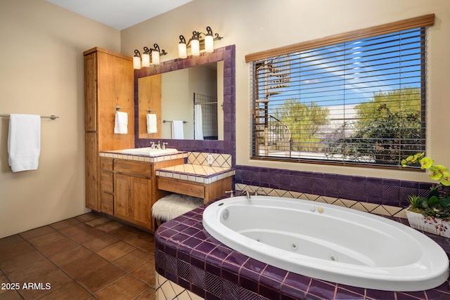 bathroom featuring tile patterned floors, vanity, and a whirlpool tub