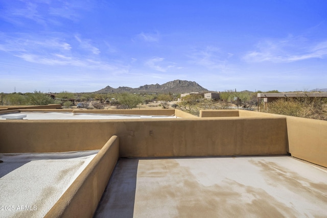 view of patio / terrace featuring a mountain view and a balcony