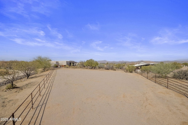 view of community featuring a rural view and fence