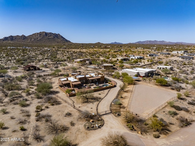 drone / aerial view featuring a desert view and a mountain view