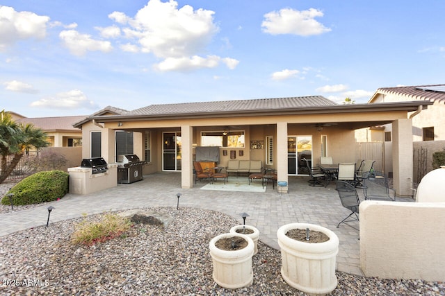 back of house featuring an outdoor kitchen and a patio area