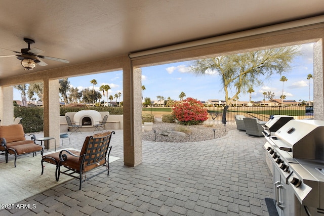 view of patio / terrace featuring area for grilling and ceiling fan