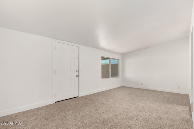 unfurnished room with carpet floors and baseboards