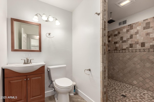 bathroom featuring visible vents, a tile shower, and toilet