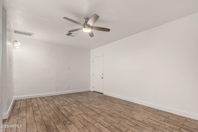 empty room with visible vents, ceiling fan, and light wood-style flooring