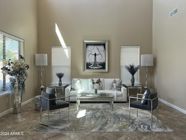 living room featuring a towering ceiling