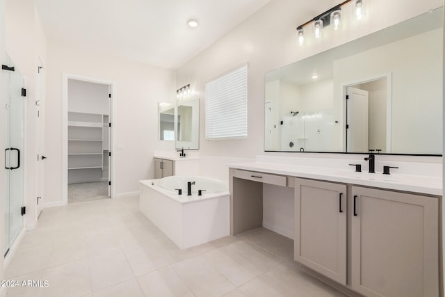 bathroom with tile patterned flooring, vanity, and plus walk in shower